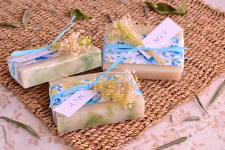 Blue wedding favors decoration handmade soaps with flowers and label with monogram letters of bride groom names, guest gifts, party souvenirs