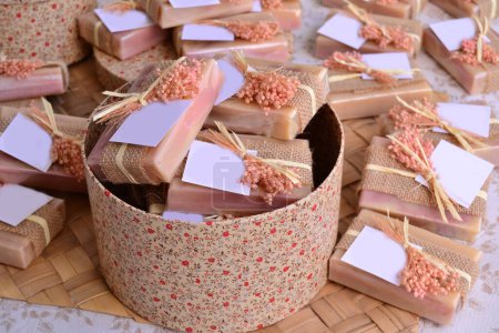 Fall wedding decoration handmade soaps for guest gifts, round box on favor table with party custom souvenirs  in beige brown color, autumn rustic style decor jute and flowers