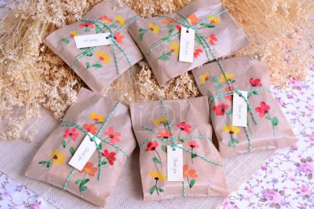 Paper bags with small gifts for guests, wedding favors with ribbon decoration and thank you label, original handmade diy summer party souvenirs, brown and natural colors country rustic style celebration