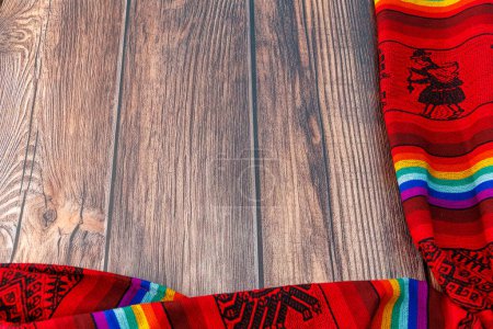 Photo for Wooden table with fabrics made manually by people who live in the Peruvian mountains from pre-Hispanic times with embroidery and bright colors - Royalty Free Image