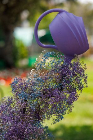 Photo for Floral arrangement with a watering can producing flowers as if they were water - Royalty Free Image