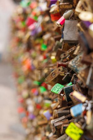Photo for Padlocks placed on the fence of a bridge reflecting the love of couples - Royalty Free Image