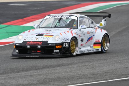 Photo for Scarperia, 2 April 2023: Porsche 993 GT2 Evo year 1999 in action during Mugello Classic 2023 at Mugello Circuit in Italy. - Royalty Free Image