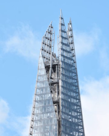 Photo for Tip of The Shard in London against a partly cloudy sky, modern architecture - Royalty Free Image