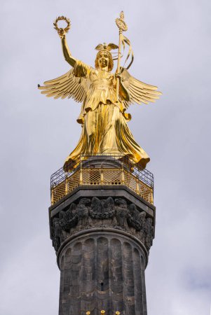 Photo for Closeup of the golden Winged Victory Angle at the top of the Berlin Victory Column (Siegessule) located in Tiergarten - Royalty Free Image