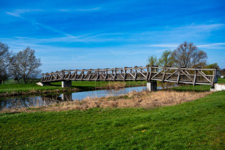 Photo for A view of the wooden bridge over the river Unstrut in Schoenfeld near Artern in Germany - Royalty Free Image
