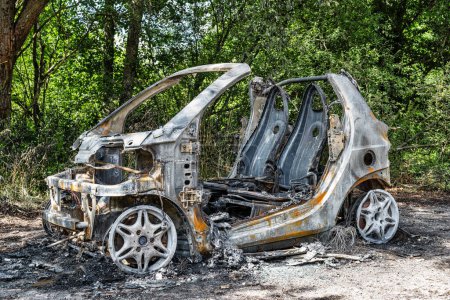 Photo for A view of a burnt-out car in the forest in the Harz Mountains in Germany - Royalty Free Image