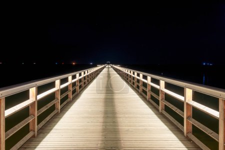 Photo for A view of the pier in Ahlbeck on the Baltic Sea at night on the island of Usedom - Royalty Free Image
