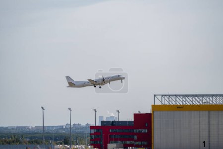 Photo for An airplane flying low on landing at Leipzig Airport - Royalty Free Image