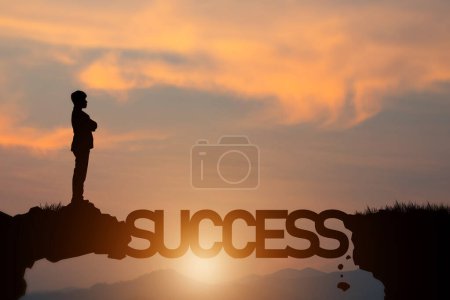 silhouette of a person walking on the stairs and holding up a word success on the sunset