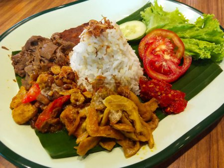 Photo for Nasi Gudeg - Vegan Gudeg Rice. A typical rice dish from Yogyakarta. Jackfruit stew, krecek, mushrooms and various vegan food ingredients - Royalty Free Image