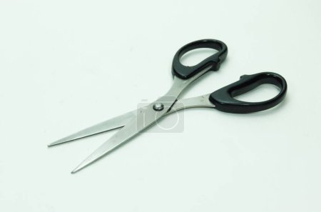 Metal scissors, black handles for tailoring, quilting and needle work. Scissors isolated on white background