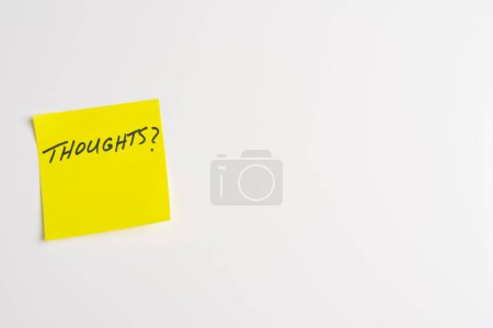 The word Thoughts on a yellow sticky note posted on an isolated white background