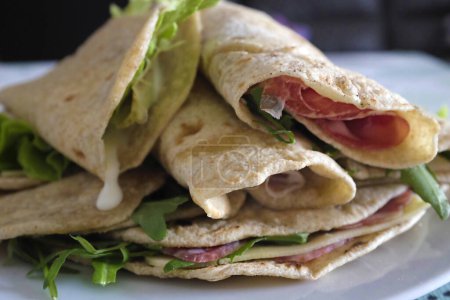 Photo for Rolled piadina with raw ham and cheese - Royalty Free Image
