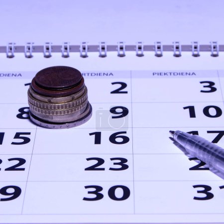 Photo for Blue ballpoint laying on a calander - Royalty Free Image