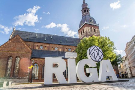 Photo for Riga, Latvia- July 7, 2023: Dome Square with Riga Cathedral in old town with Riga sign in front - Royalty Free Image