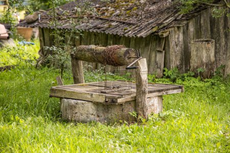 old well,ancient draw-well in the european countryside.