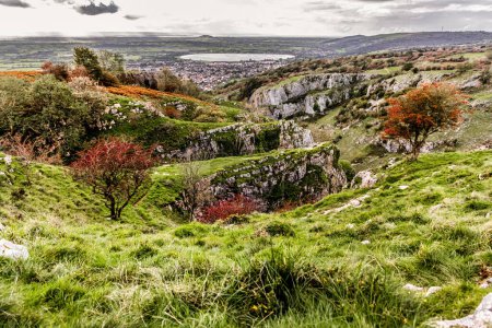 View from cliff edge of winding road Cheddar Town Gorge in Somerset in autumn.