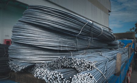 Photo for Ready-to-ship round bars, DB steel used in construction, tying bar beams, Metal round pipe  Steel in bulk, centered image - Royalty Free Image