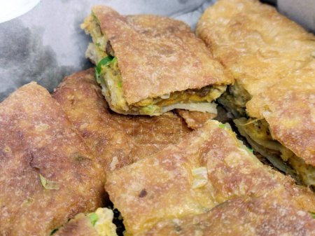 Photo for Martabak Telur close up photo. One of Indonesian food. Savory pan-fried filled with eggs, spring onions and meat. - Royalty Free Image