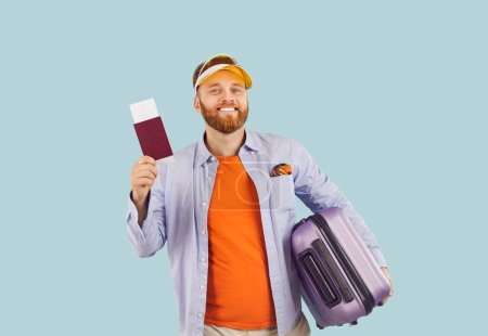 Happy man holding passport with airline ticket, tourist dreaming of flight, ready to go. Planning holiday aircraft journey, domestic, international travelling, emigration, relocation trip, departure