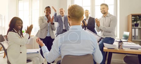 Photo for Business man sitting back speaking on a work meeting in office in front of a group of company employees discussing new project, applauding their leader celebrating success, making deal. Banner. - Royalty Free Image