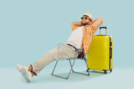 Summer vacation man beach wear, sitting relaxed in tourist chair enjoying trip holiday. Holidaymaker recreation, travelling pleasure, happy rest, relaxation, enjoyment to become less tired or anxious
