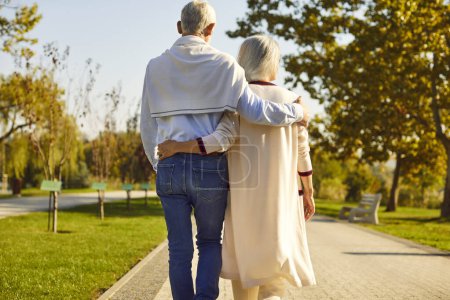 Photo for Happy senior couple, during walking through a serene city park. Engaged in an active and leisurely stroll, this charming pair enjoys the simple pleasures of a vacation and holiday. - Royalty Free Image