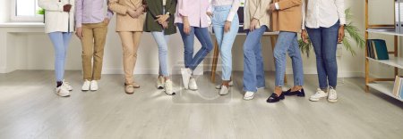 Photo for Legs of a group of unrecognizable business people women standing in a row at the office on workplace. Cropped shot of a stylish group of employees or staff in casual clothes. Banner. - Royalty Free Image