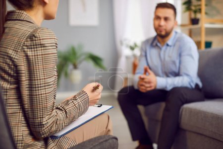 Photo for Woman reporter is conducting an interview and talking with a businessman on a TV show. The businessman is the guest, and the interview is part of the press and PR activities, with the woman host. - Royalty Free Image