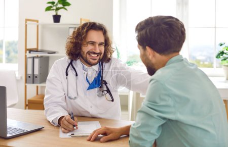 Man patient in medical office listening to a friendly doctor holding report file with appointment and giving consultation during medical examination in clinic. Health care and medicine concept.