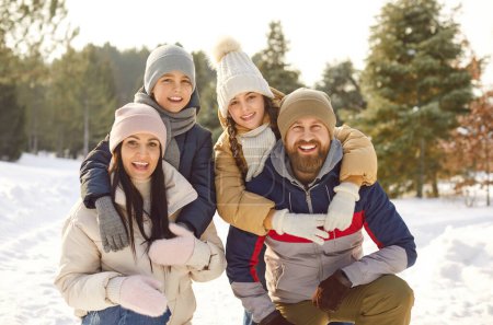 Photo for Happy family winter portrait, vacation, spending weekend outdoor, parent, children enjoy holiday together. Friendly smiling to celebrate New Year, Christmas holiday season amusement, nature recreation - Royalty Free Image