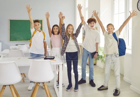 Photo for Full length portrait of a diverse group of children standing in a school classroom. Radiating happiness, teenager students share genuine smiles, embodying the joy of shared education experiences. - Royalty Free Image