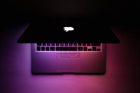 Photo for A macbook with purple glow in the dark - Royalty Free Image