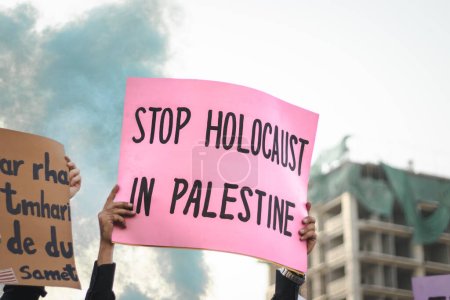 Photo for Stop holocaust in palestine with a blue smoke bomb in a protest - Royalty Free Image