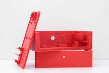 Photo for 3d printing red plastic case isolated on white background, produced from pla, horizontal view, macro - Royalty Free Image