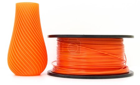 Photo for Orange vase and filament for 3d printing, isolated on white background, produced from pla, horizontal view, macro - Royalty Free Image