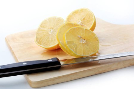 Photo for The yellow lemon and knife on the board - Royalty Free Image
