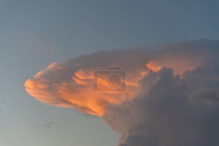 Photo for Capture the mesmerizing beauty of a sunset with our stunning photograph featuring a gradient of pink and blue hues in the evening sky, adorned with dramatic cumulonimbus clouds. Ideal for stock agencies seeking captivating nature and weather imagery. - Royalty Free Image