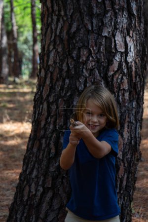 Photo for Child playing with a stick imagining it is a gun - Royalty Free Image