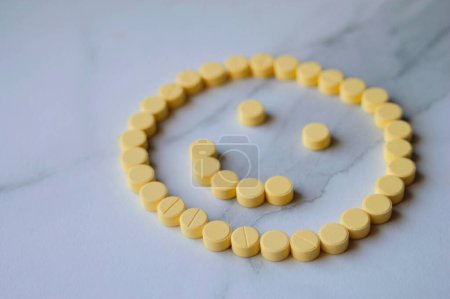Photo for Happy face made with yellow medicine pills - Royalty Free Image