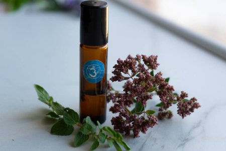 Bottle of essential oil with aromatic plants