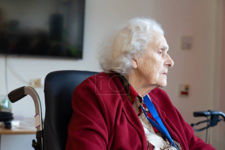 Elderly woman in a wheelchair in a nursing home