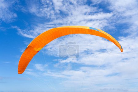 Téléchargez les photos : Voile orange parapente avec fond bleu ciel avec espace de copie - en image libre de droit