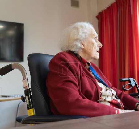 Elderly woman in a wheelchair in a nursing home