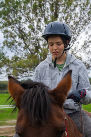 Teenage woman doing equine therapy