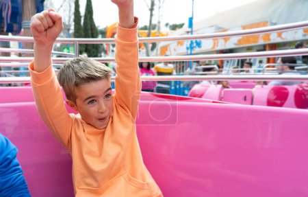 Child having fun on the cup attraction at an amusement park