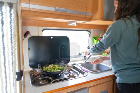 Woman cooking in a motorhome