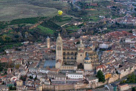 City of Segovia seen from the air with a hot air balloon flying over the city