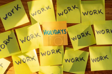 Photo for Post it with the word work and one in the center with the word holidays - Royalty Free Image